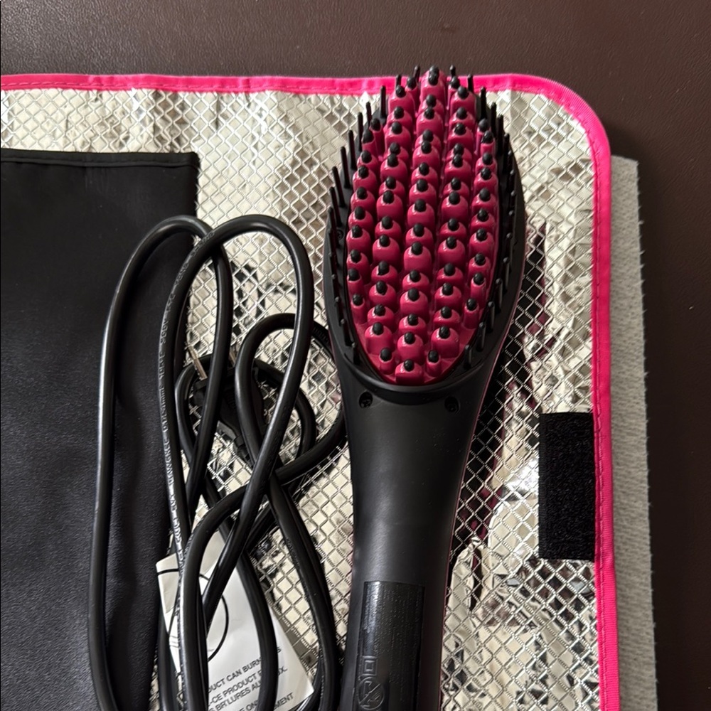 Black and Pink Electric Hair Straightening Brush with case.